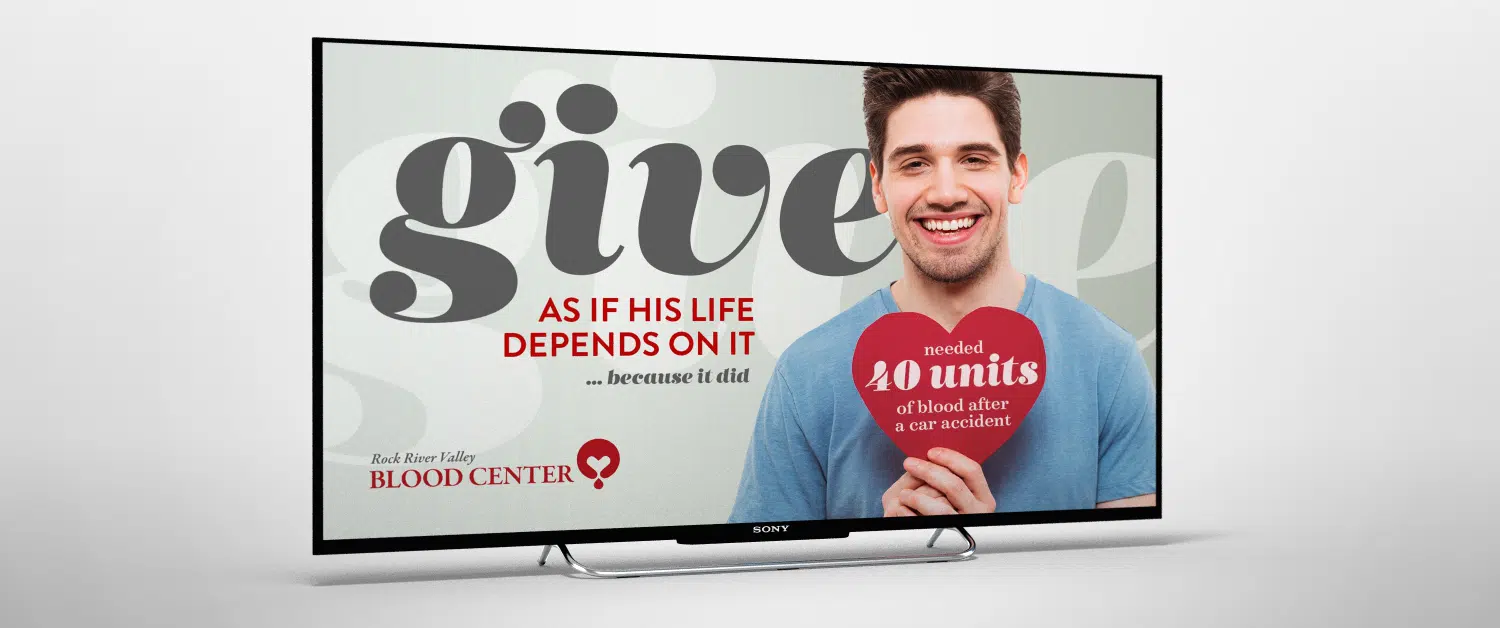 blood donation marketing campaign of man holding heart on monitor