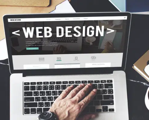laptop on desk showing web design