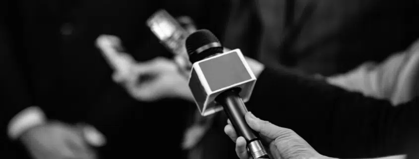 black and white image of hand holding microphone