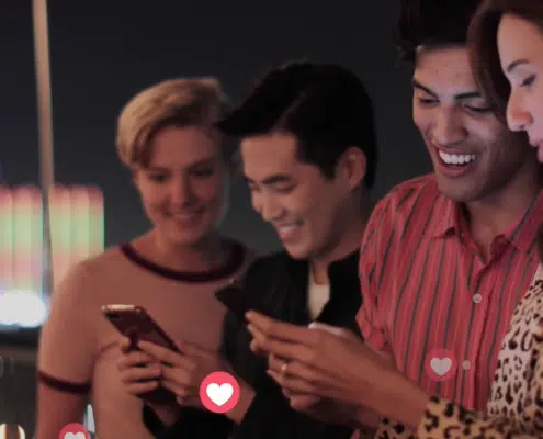 four-people-looking-a-phones-with-hearts