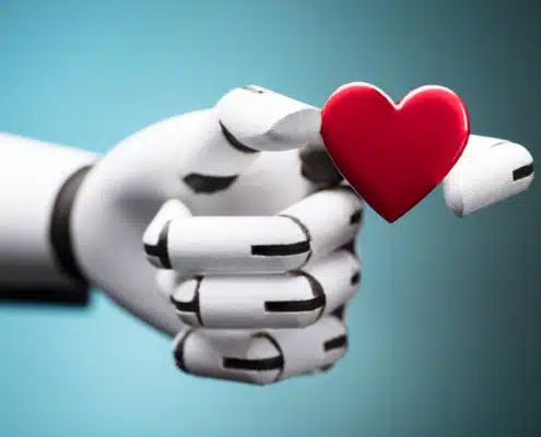 robotic hand holding red heart