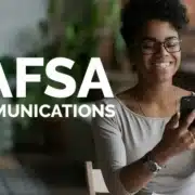 Woman holding phone while cheering for FAFSA Communications